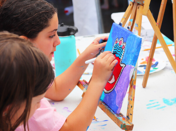 girl painting on an easel.
