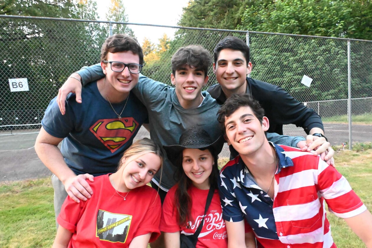 camp counselors in a group smiling.