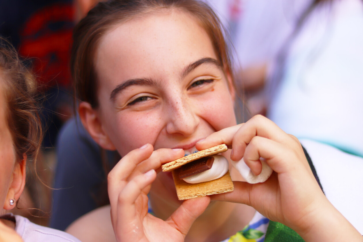 girl eating smores.