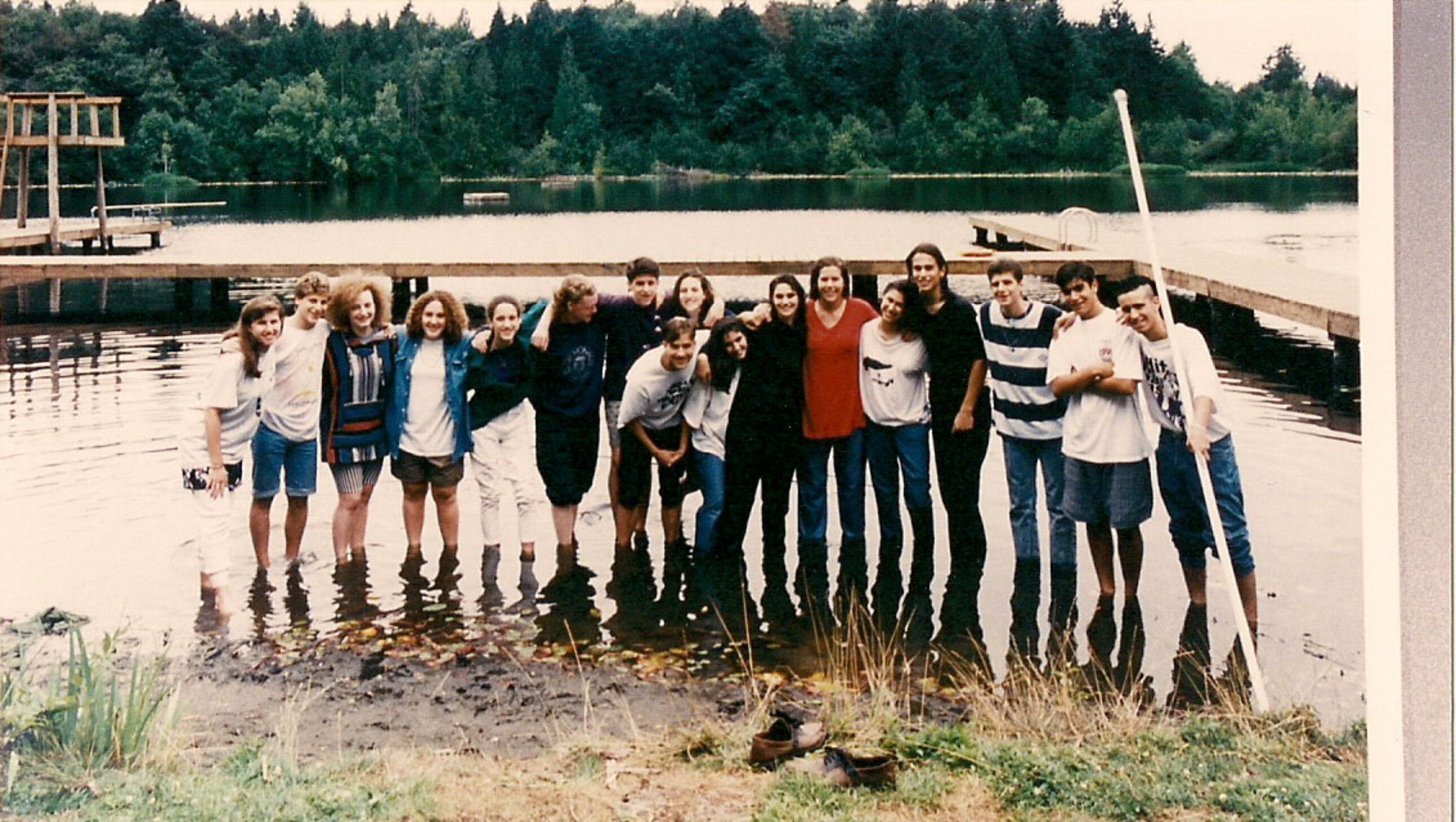 teens wading in a lake.