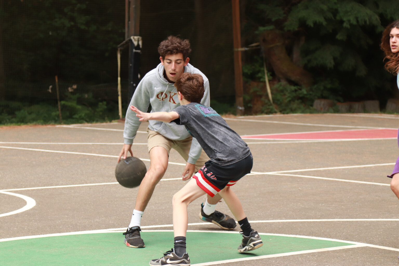 two young people playing basketball.