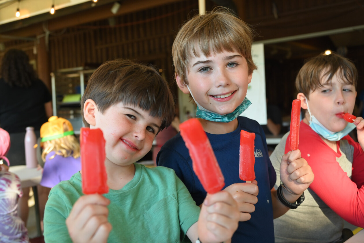 boys holding popsicles.