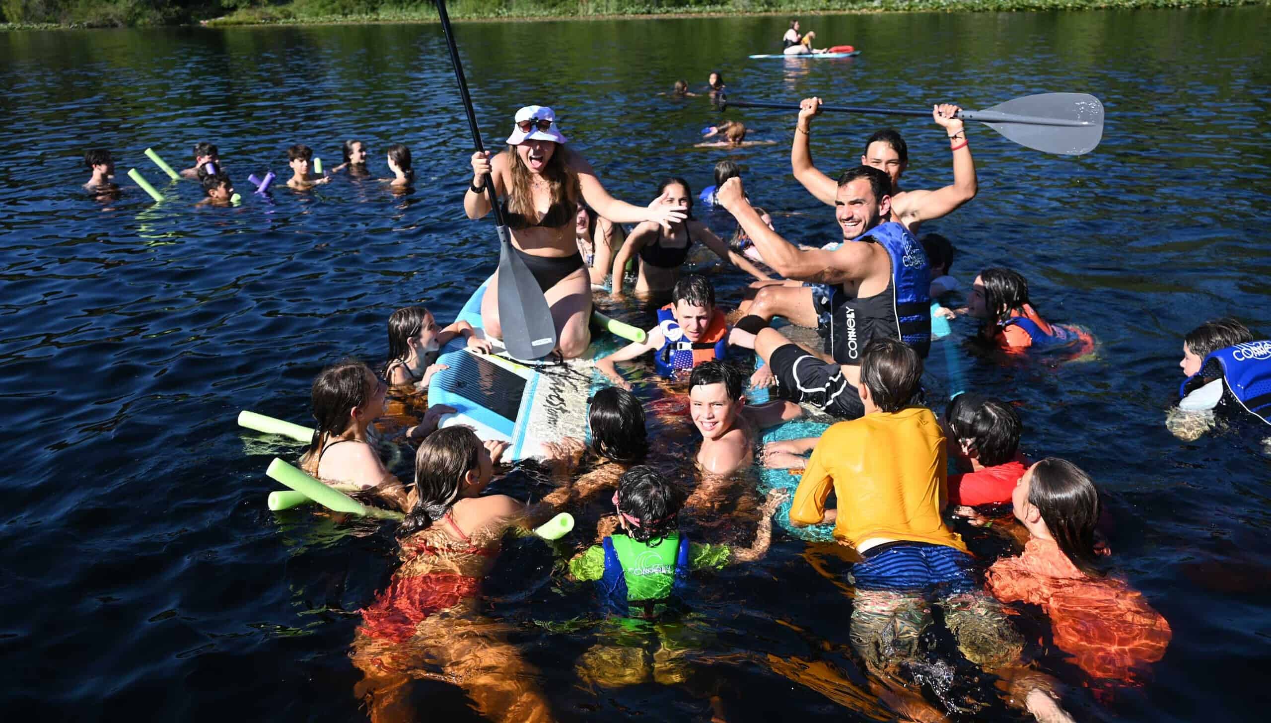 A group of campers playing in the water.
