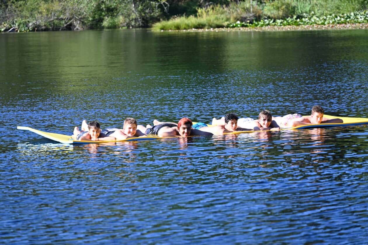 A group of campers in the water.