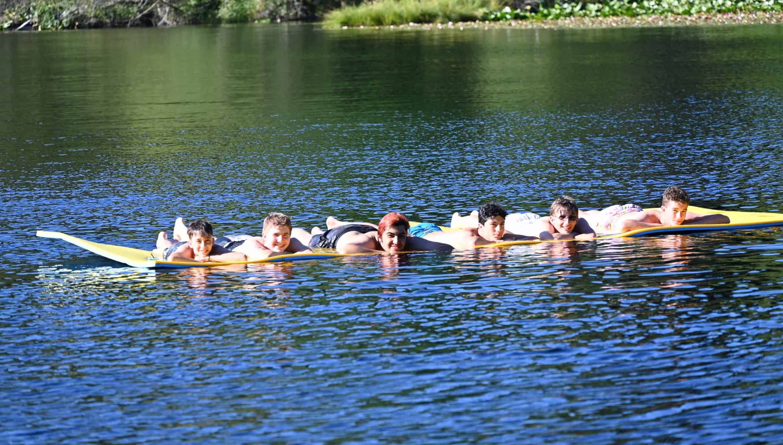 A group of campers in the water.
