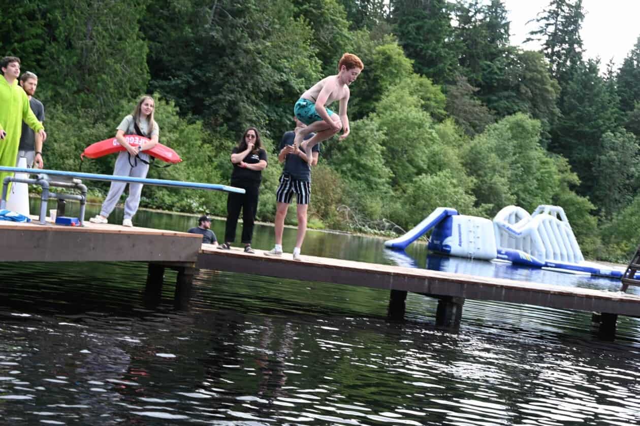 A camper jumping into the water.