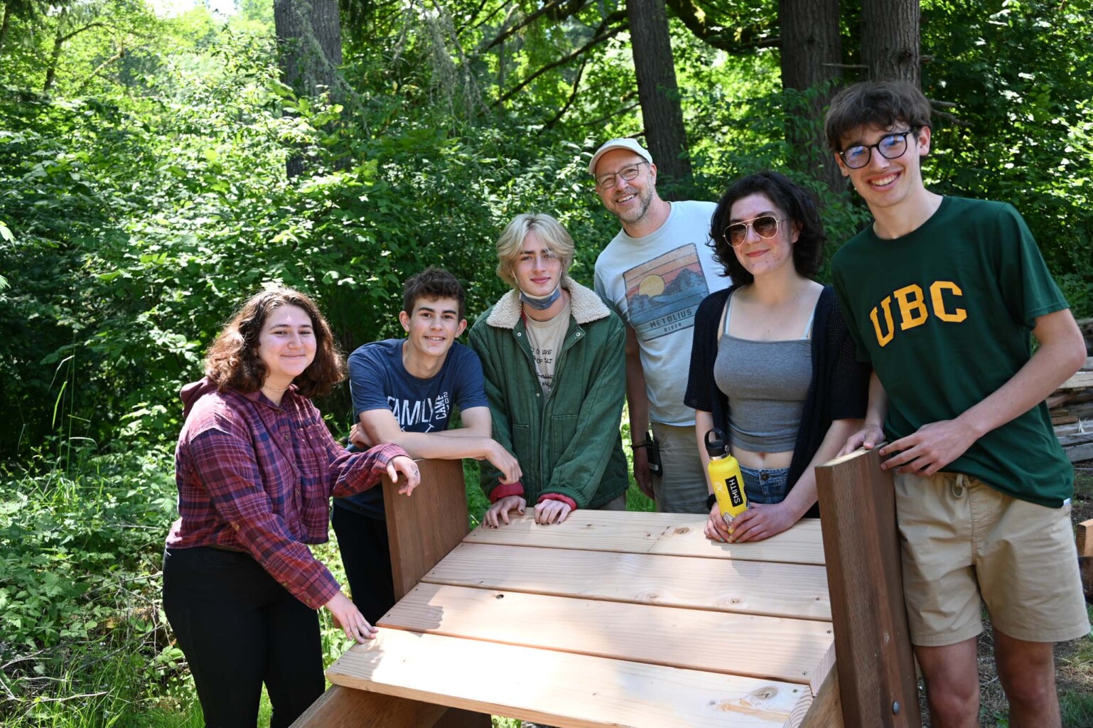 camp staff standing around a woodworking project.