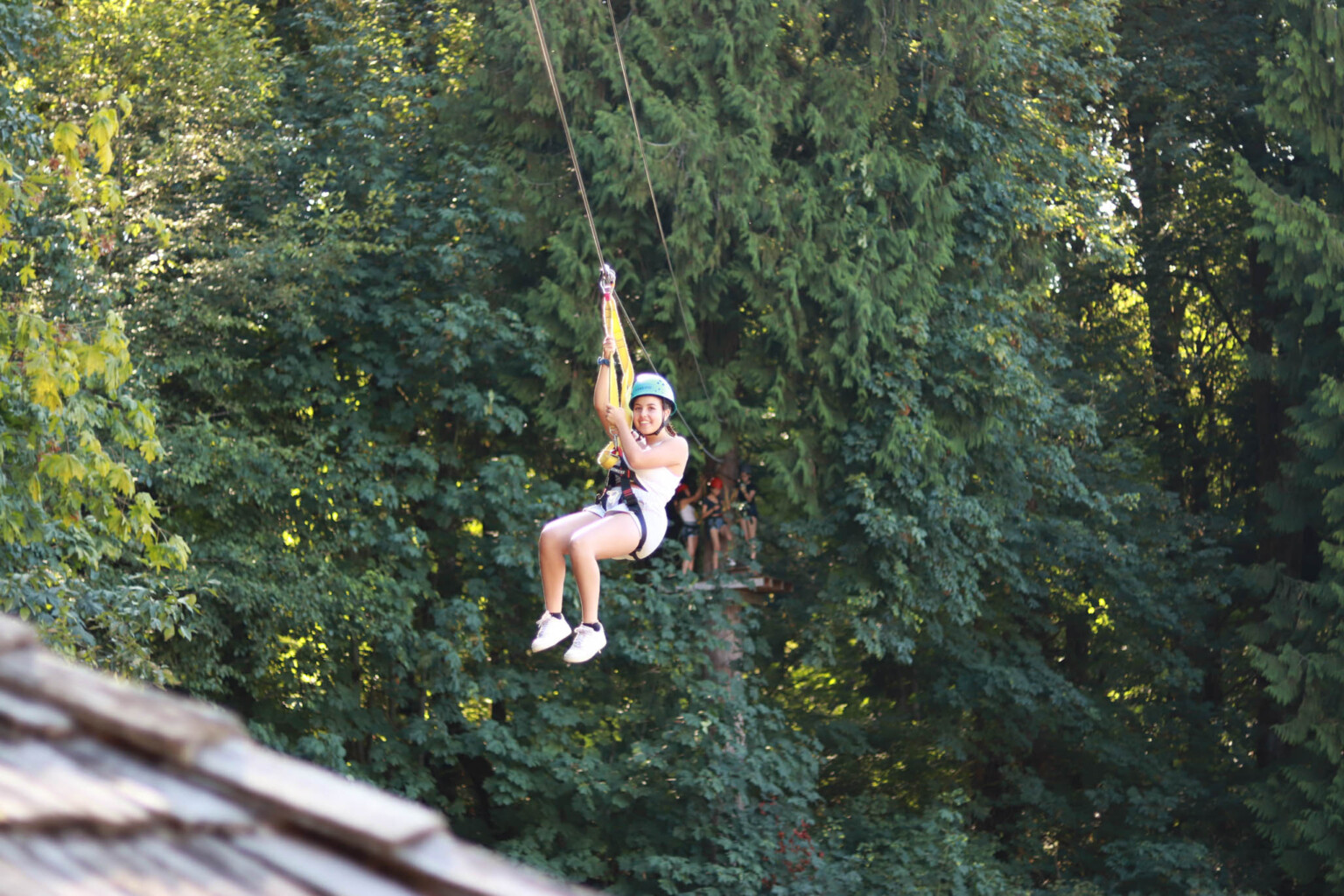 kid riding on a zip line.